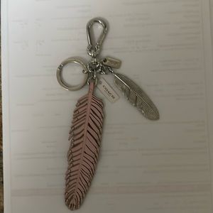 Coach pink and silver feather keychain